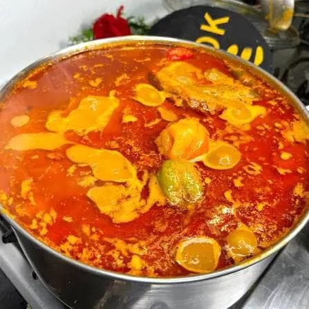 Savory peanut soup with meat, tomatoes and pepper.